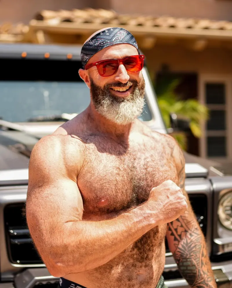 Kyle Newell outdoors, wearing his bandana and red sunglasses.