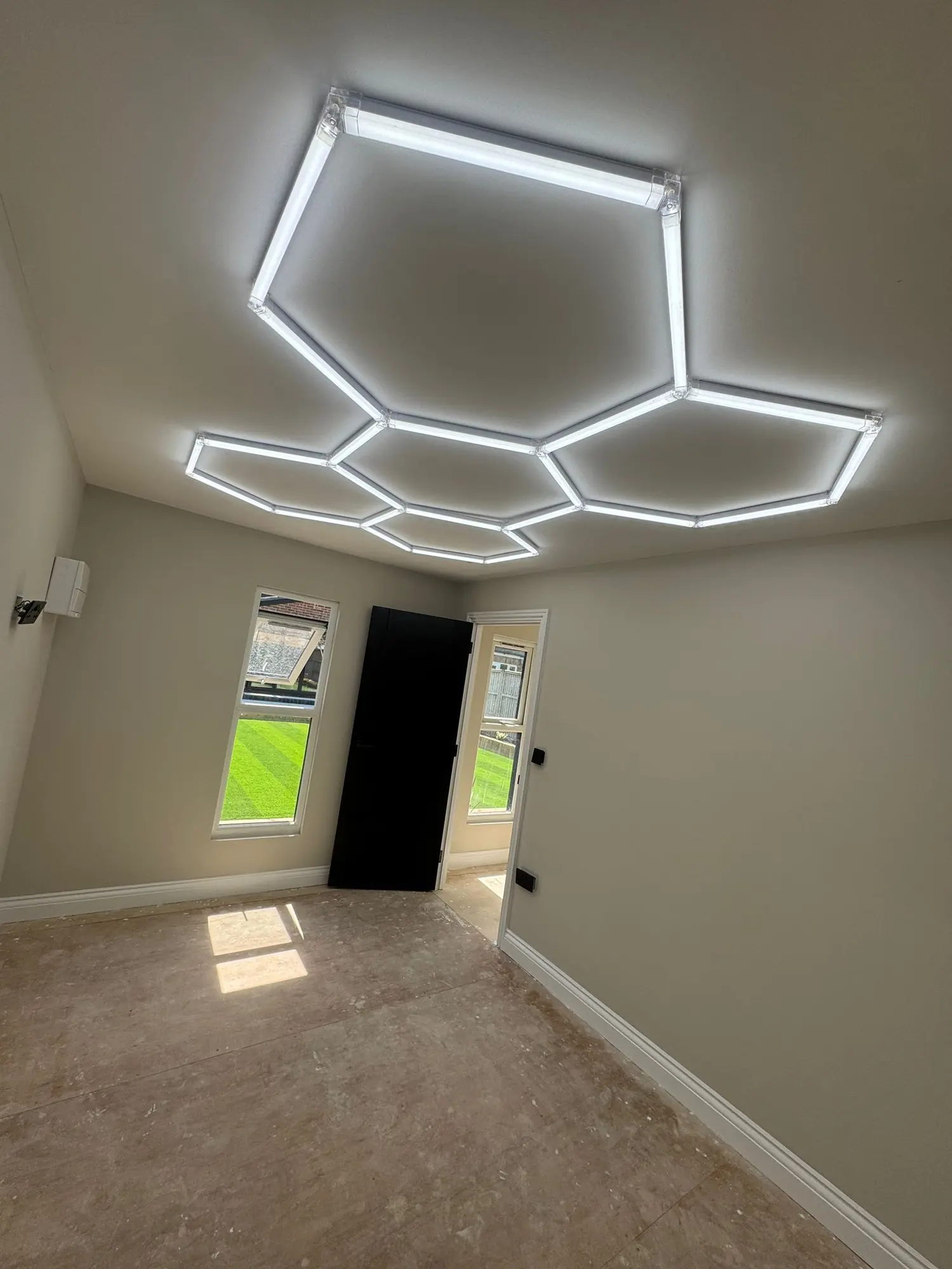Hexagonal LED grid lighting in a garage workshop