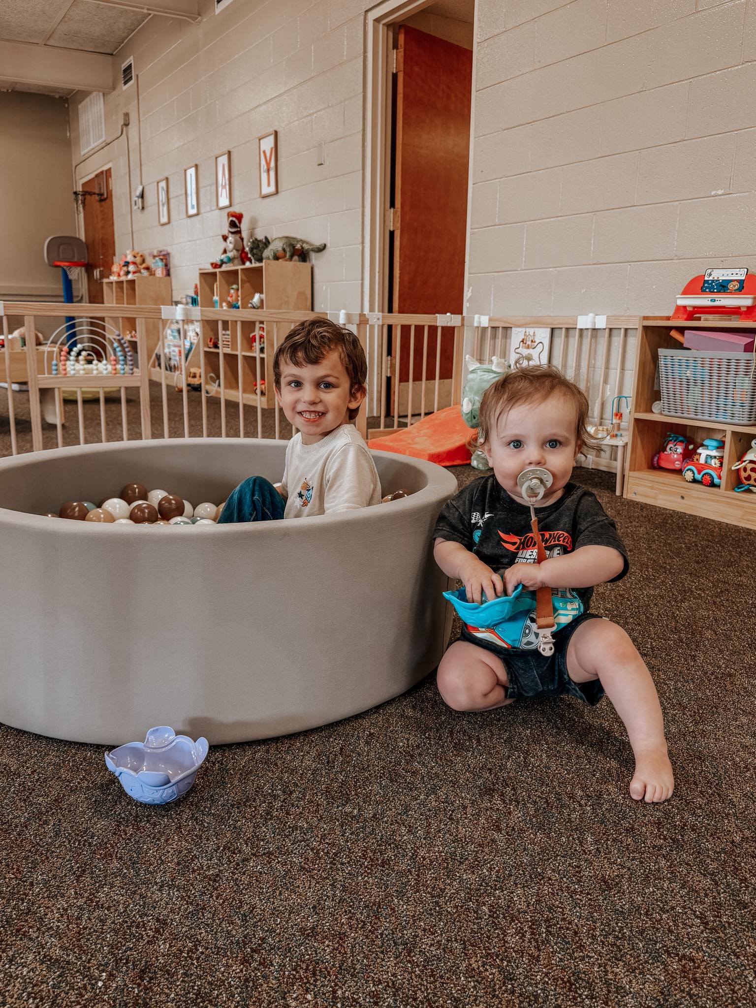 Soft play climbing structures and foam blocks in a cozy corner.