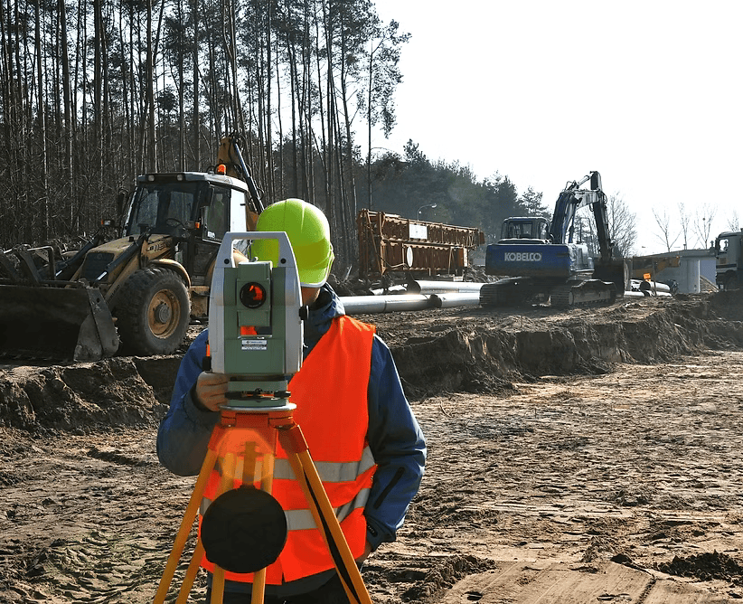 Surveyor working on an active construction site