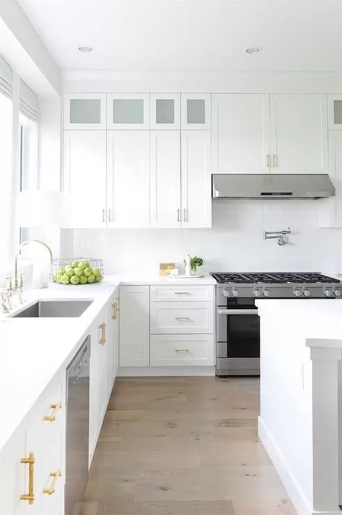 Modern white kitchen with stainless steel appliances