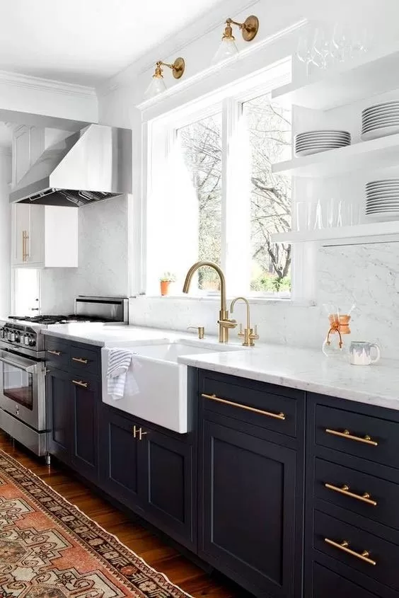 Two-tone tuxedo kitchen with white upper cabinets, a dark island and brass fixtures
