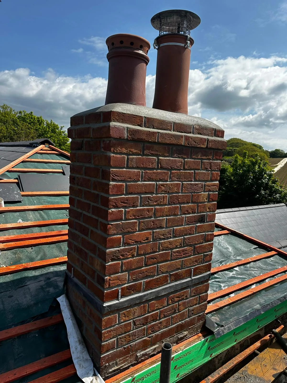 Roofline chimney work by L W Construction — rural twin-pot, Cornwall