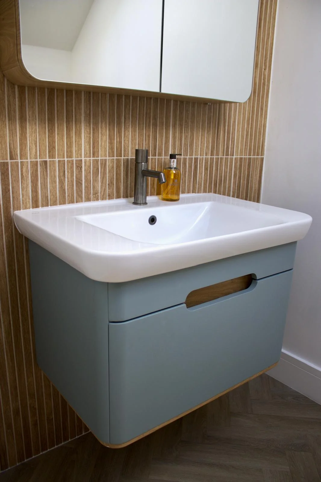 Premium Cornwall new build by L W Construction — luxury bathroom with timber vanity wall
