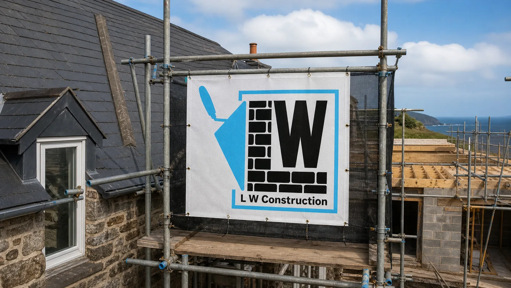L W Construction scaffolding banner on an active Cornwall build