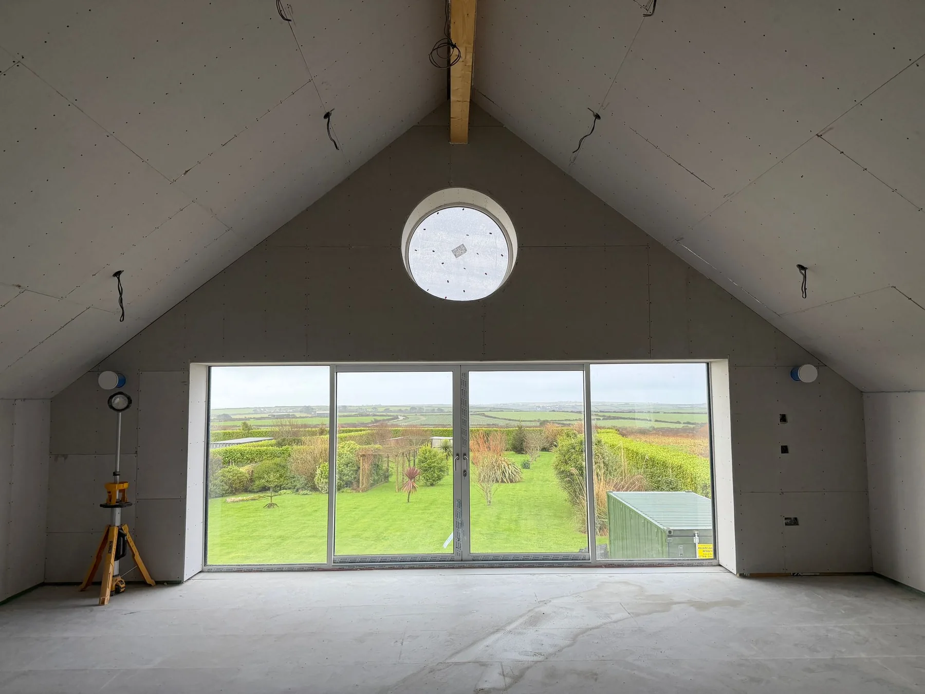 Recent Cornwall work by L W Construction — boarded shell with large glazing during build, premium new build