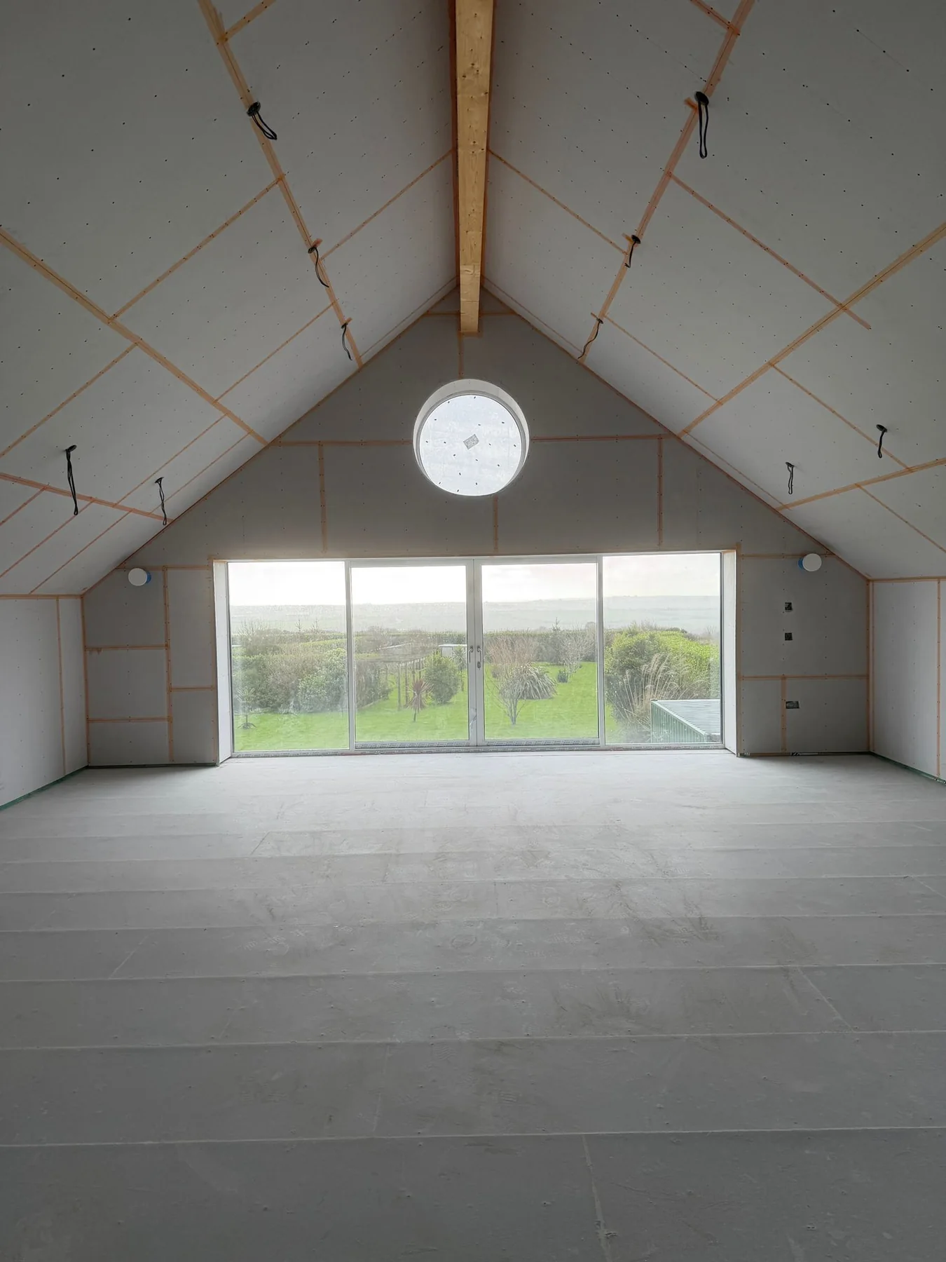 Recent Cornwall work by L W Construction — boarded kitchen shell wide during build, premium new build