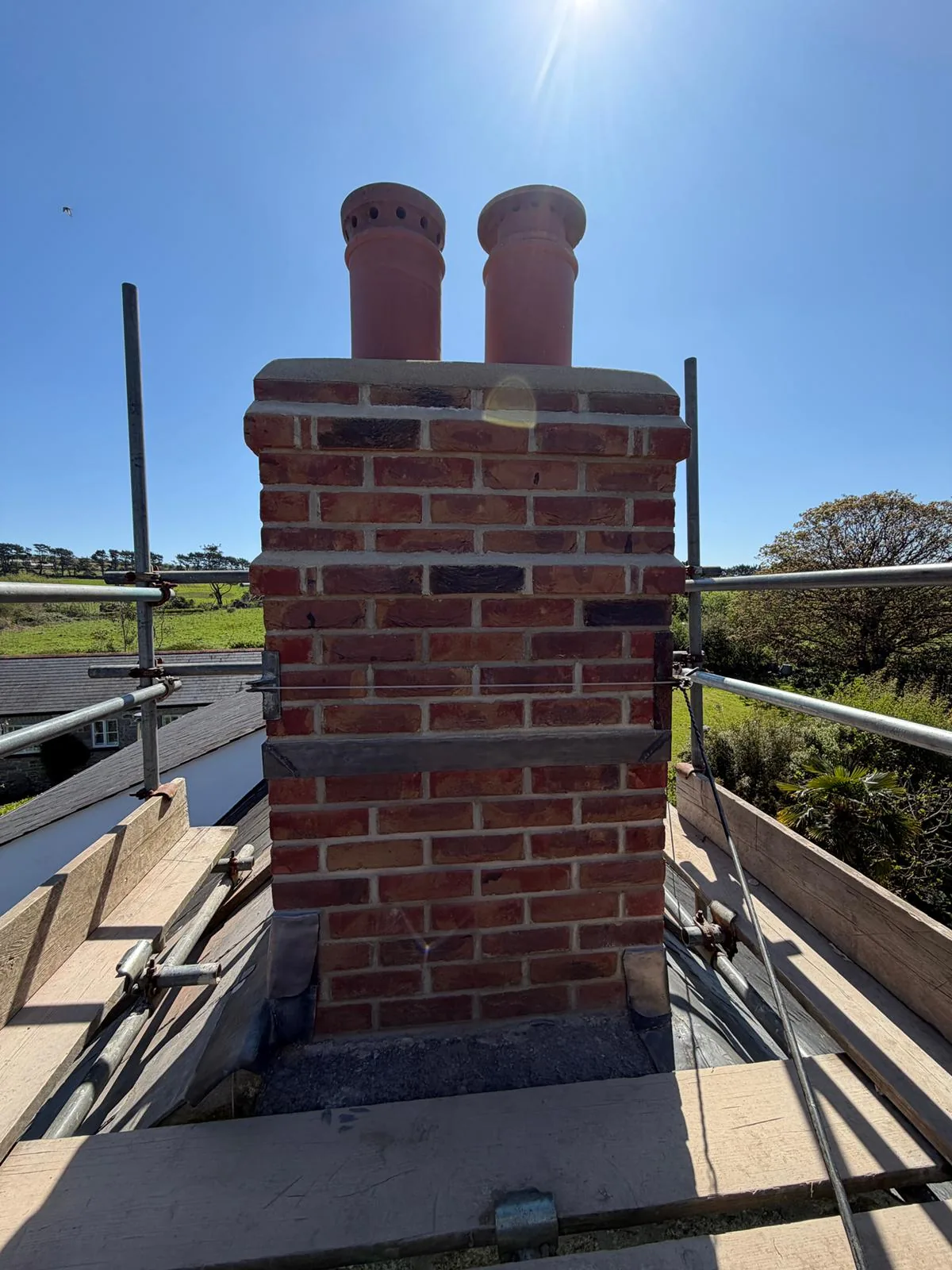 Rural twin-pot chimney rebuild by L W Construction — Cornwall — finished