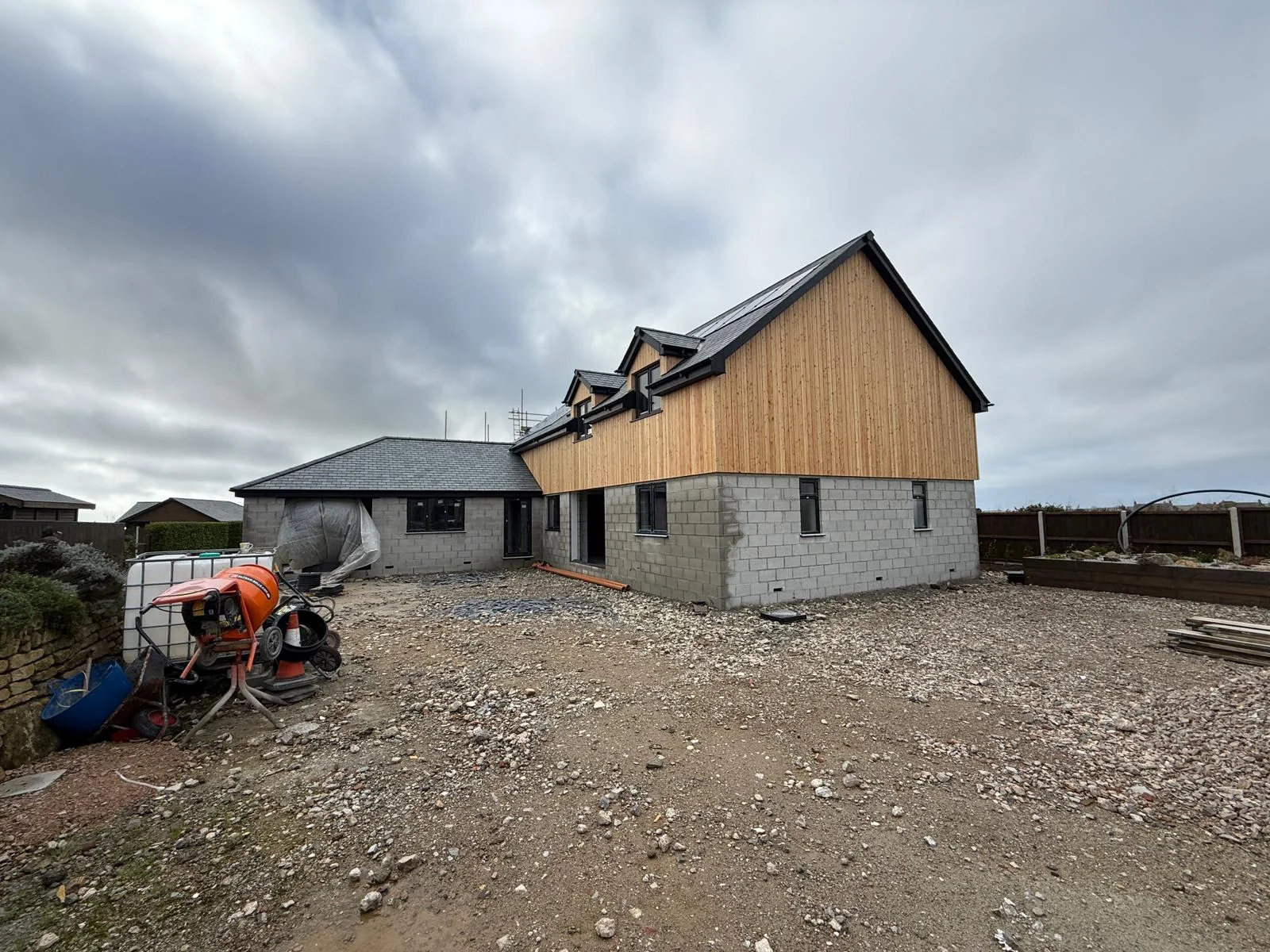 Cornwall new build by L W Construction — site progress with scaffolding and driveway groundworks during build, stage 3