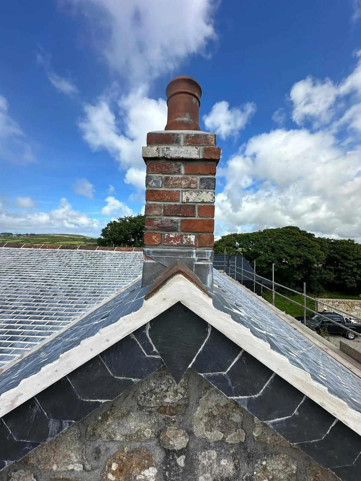 Roofline chimney repair by L W Construction — rural single-stack, Cornwall