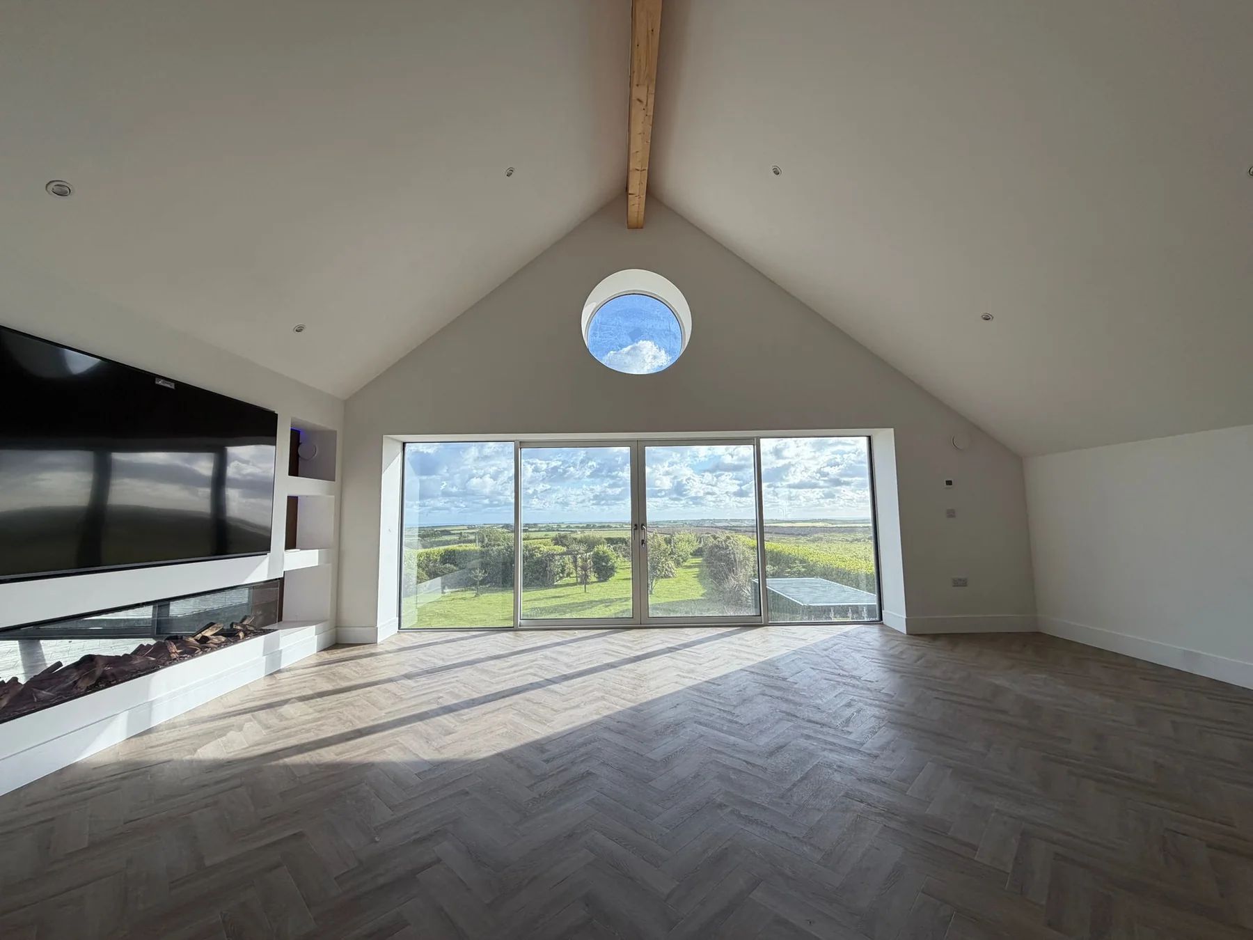 Premium Cornwall new build by L W Construction — living room with full-height glazing