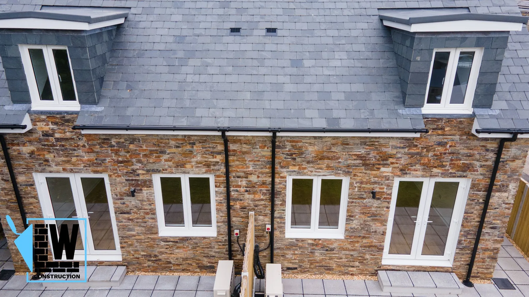 Recent new-build project by L W Construction in nearby Illogan (~2mi west of Camborne), Cornwall — front elevation wide showing twin properties