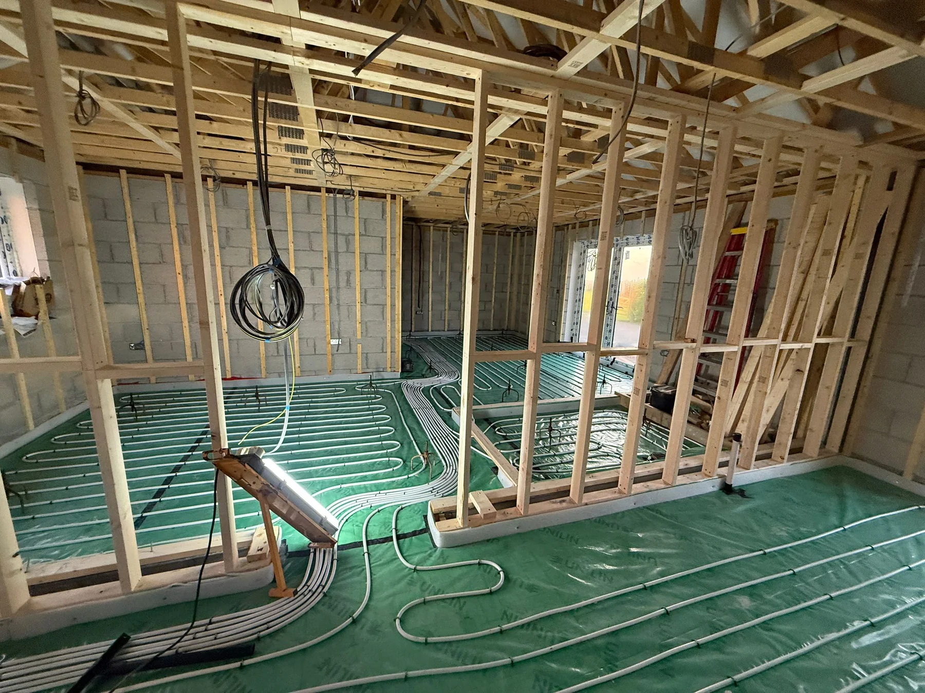 Recent Cornwall work by L W Construction — underfloor heating open-plan during build, premium new build