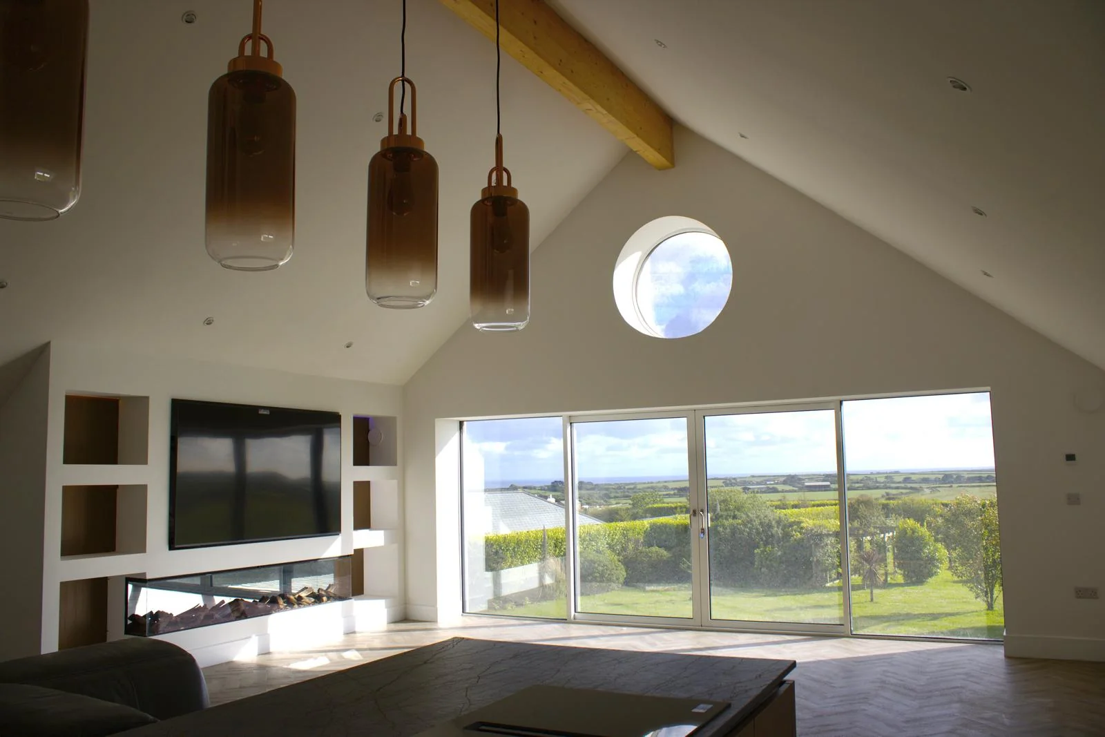Premium Cornwall new build by L W Construction — open-plan living and kitchen, wide view
