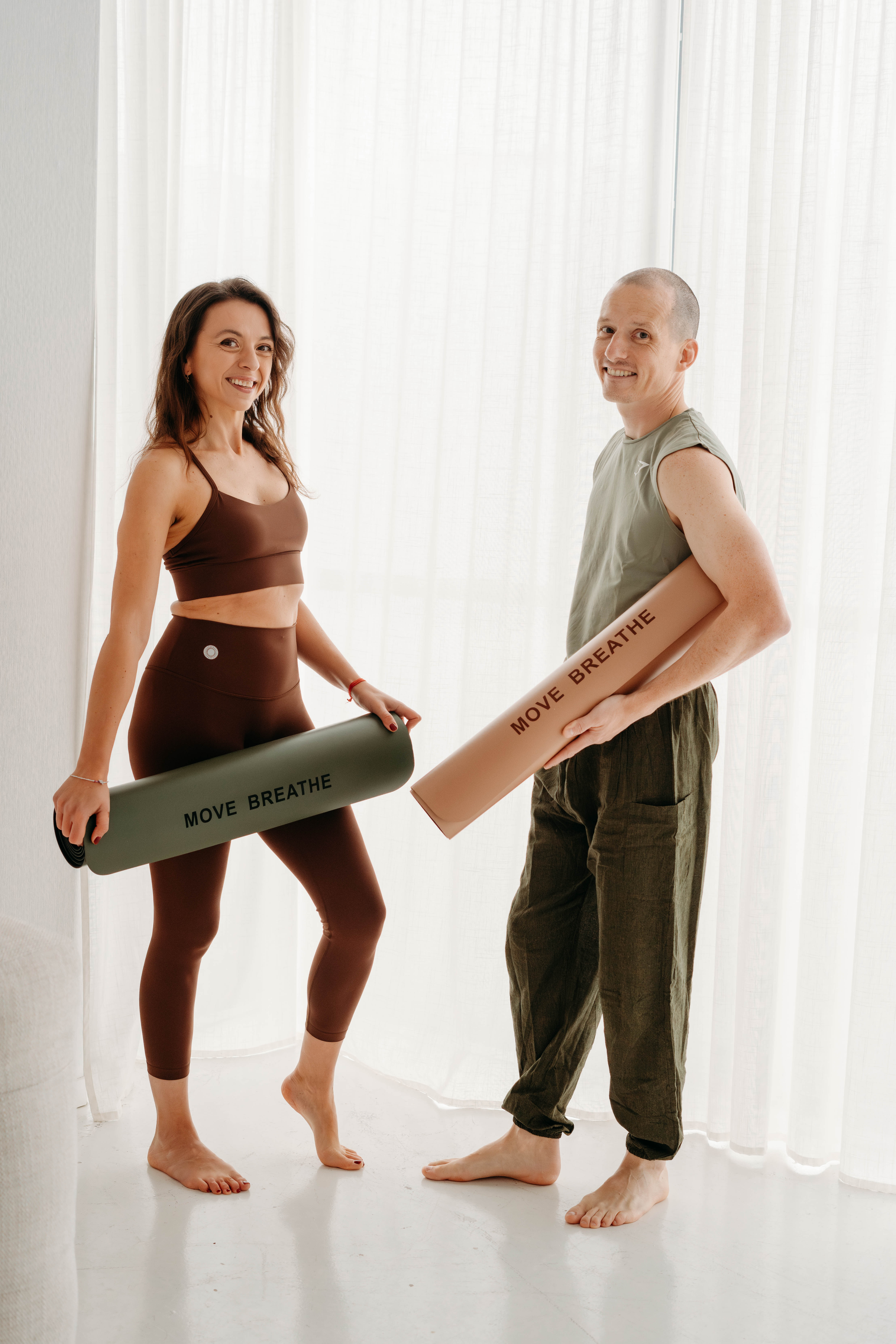 two people posing with a new yoga mat