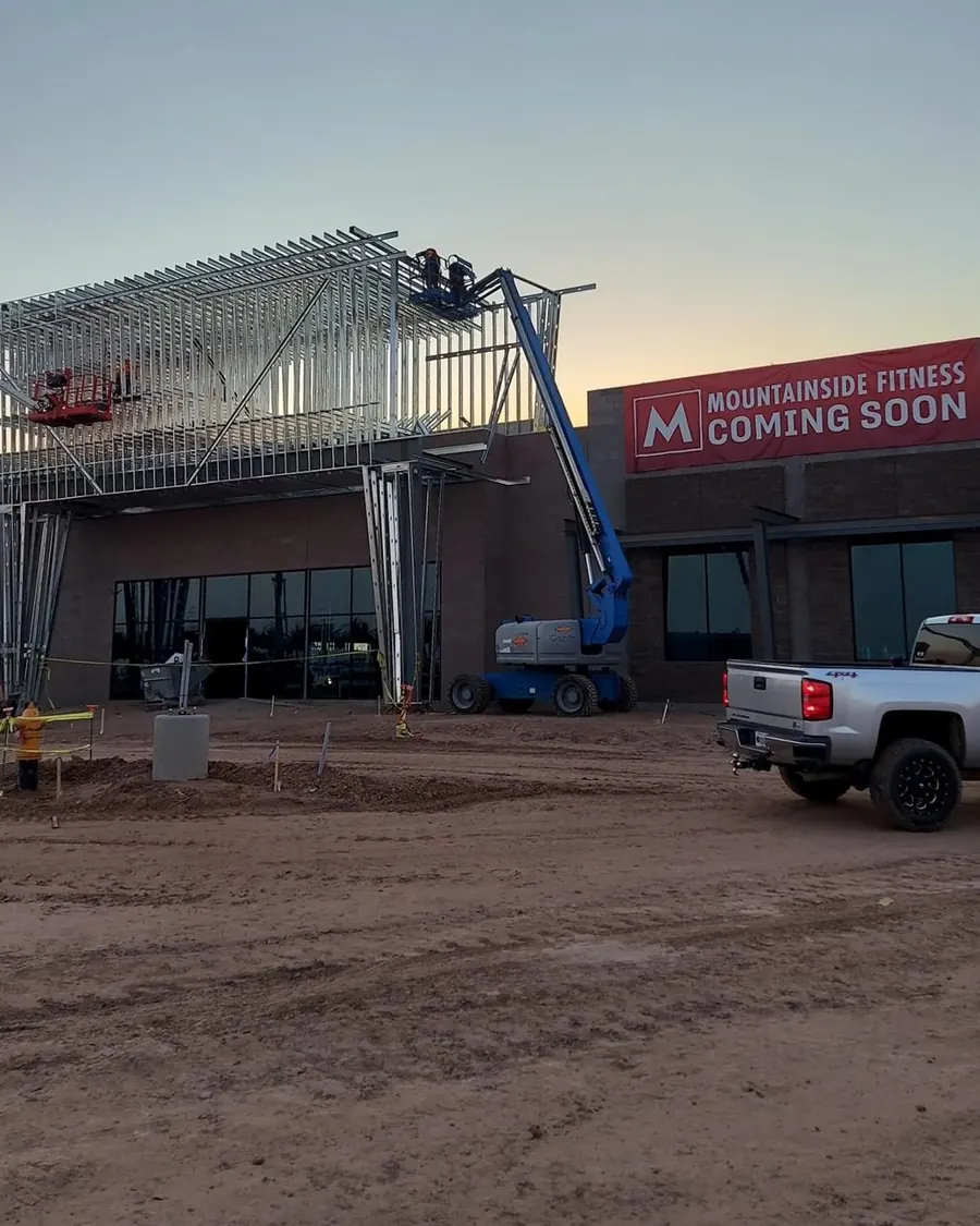 Fitness center exterior during construction with lift on site