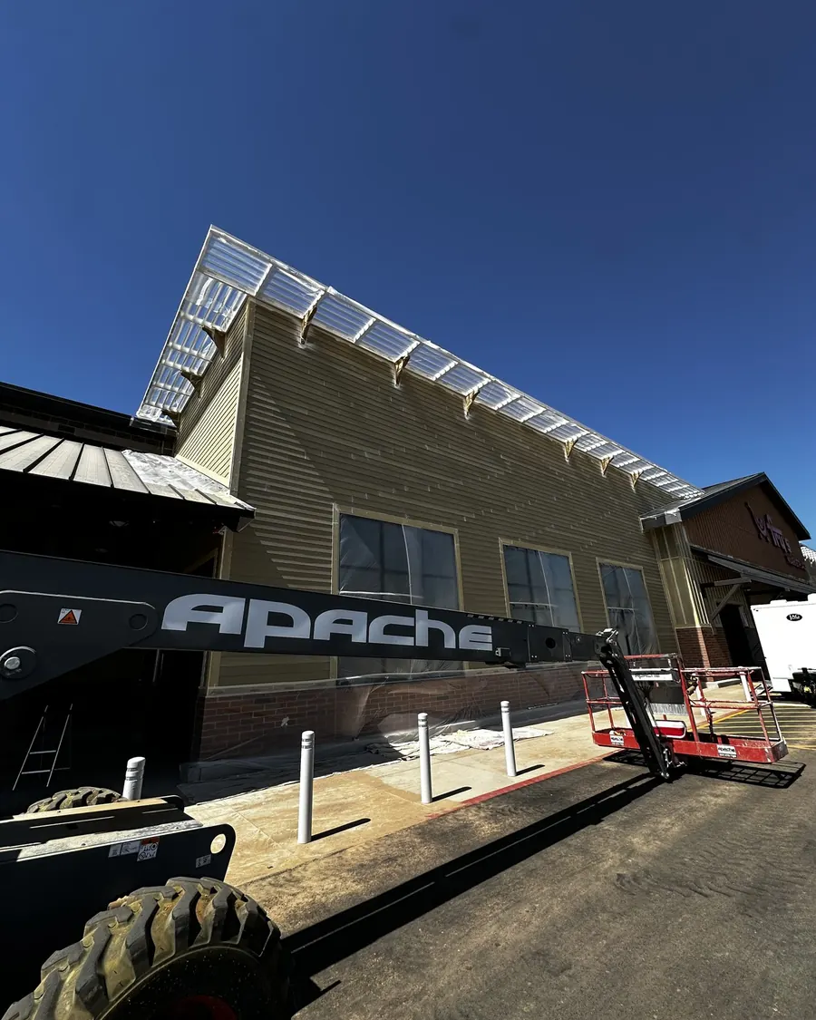 Retail building exterior in progress with lift equipment