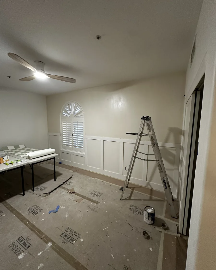 Bedroom during prep with ladder and floor protection