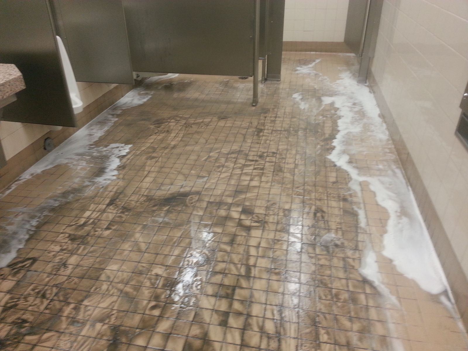 Commercial restroom tile during cleaning