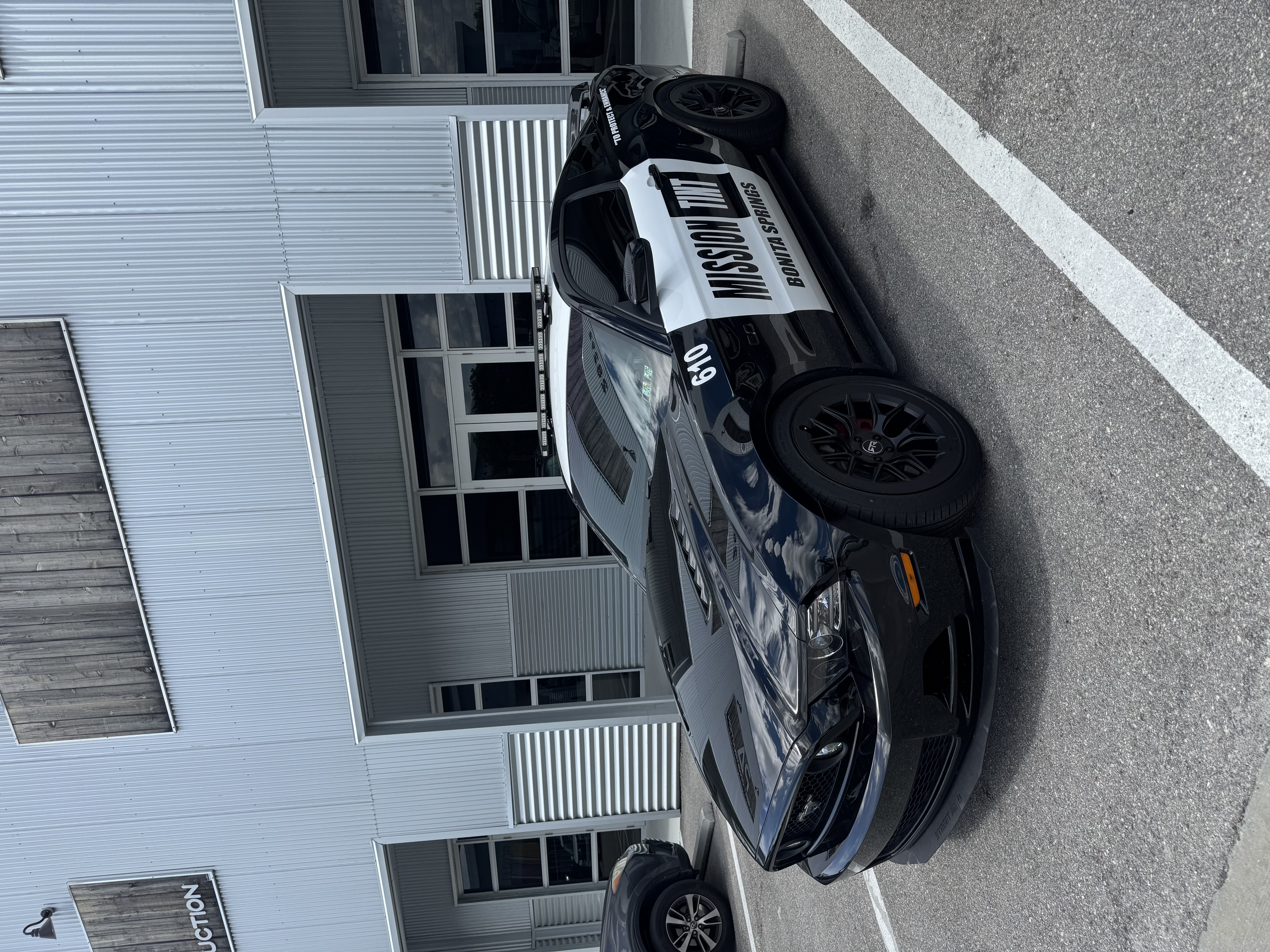 Timothy Krpata's black Ford Mustang outside the Mission Tint shop