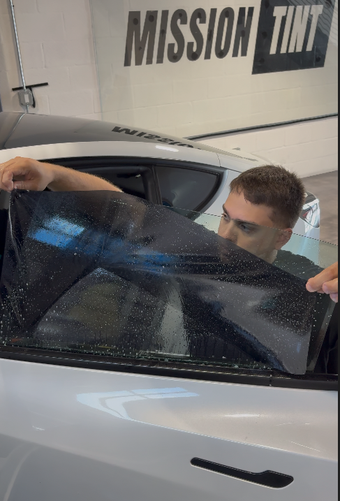 Window tint being installed on a vehicle
