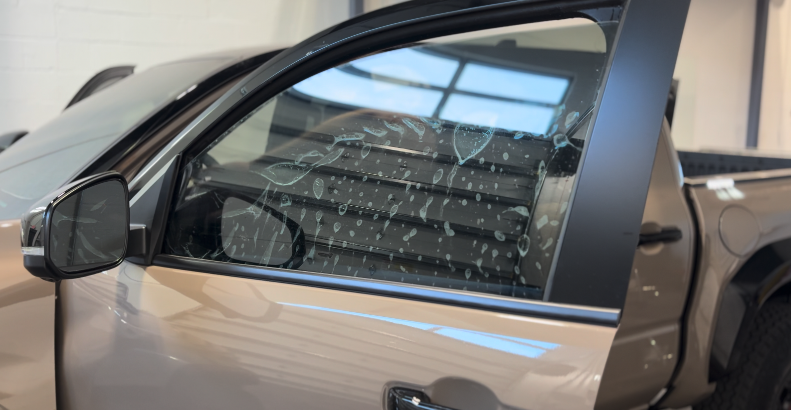 Tint film being applied to a truck window at Mission Tint