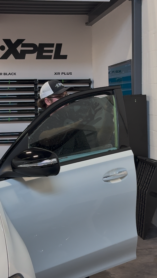 Window tint installation on a vehicle door glass