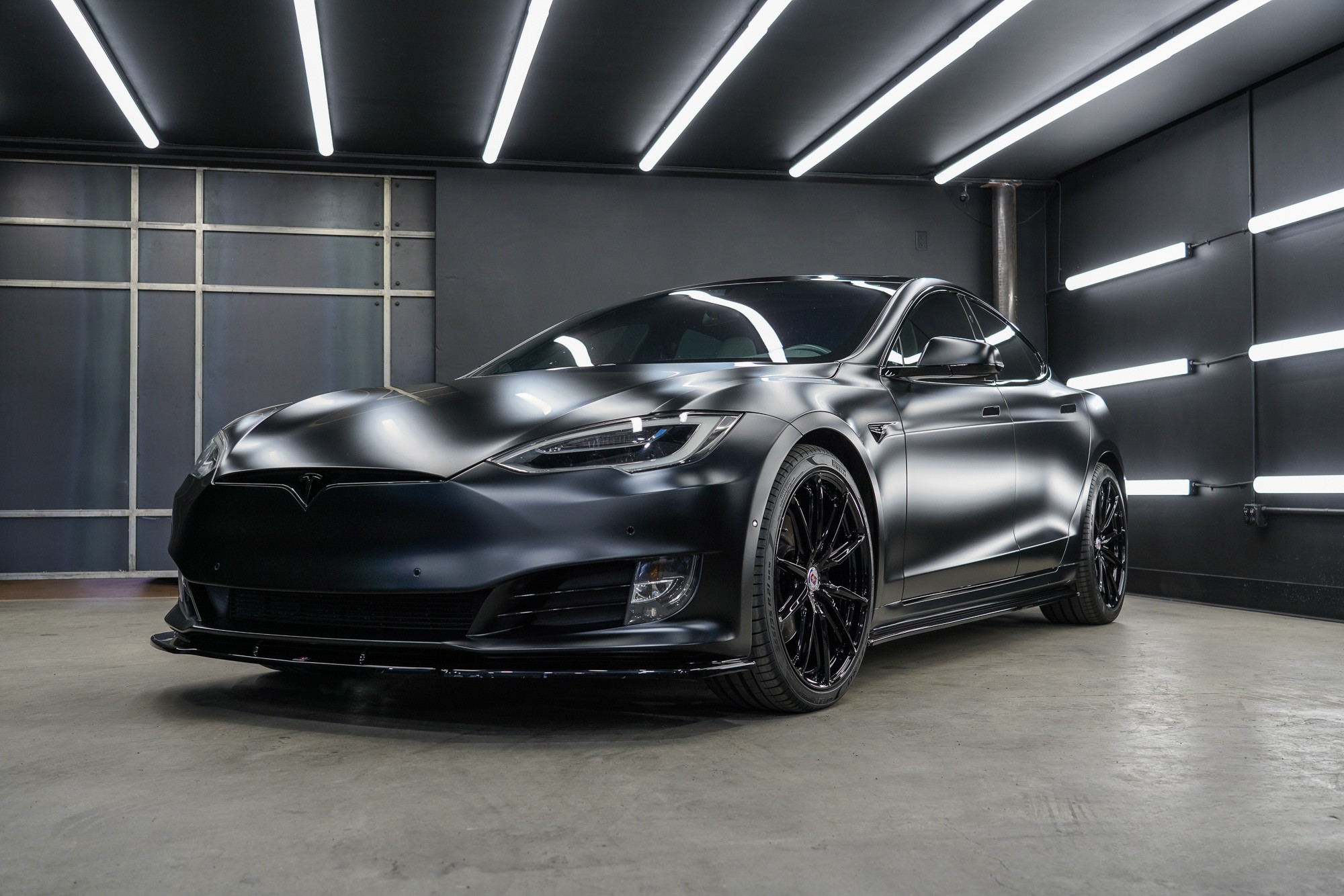 Satin black Tesla Model S with paint protection film in a studio