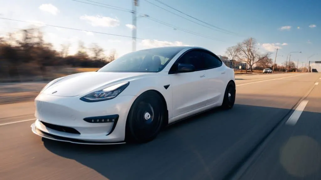 White Tesla Model 3 on the road after window tint by Mission Tint