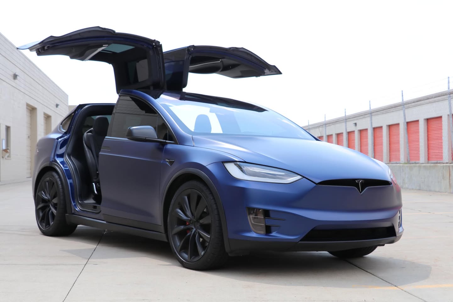 Satin blue Tesla Model X with Falcon Wing doors open after paint protection film by Mission Tint