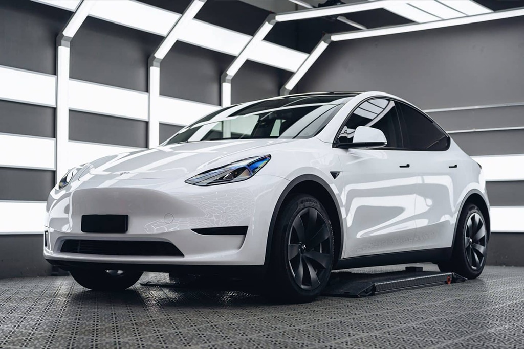 White Tesla Model Y in the Mission Tint shop after paint protection film