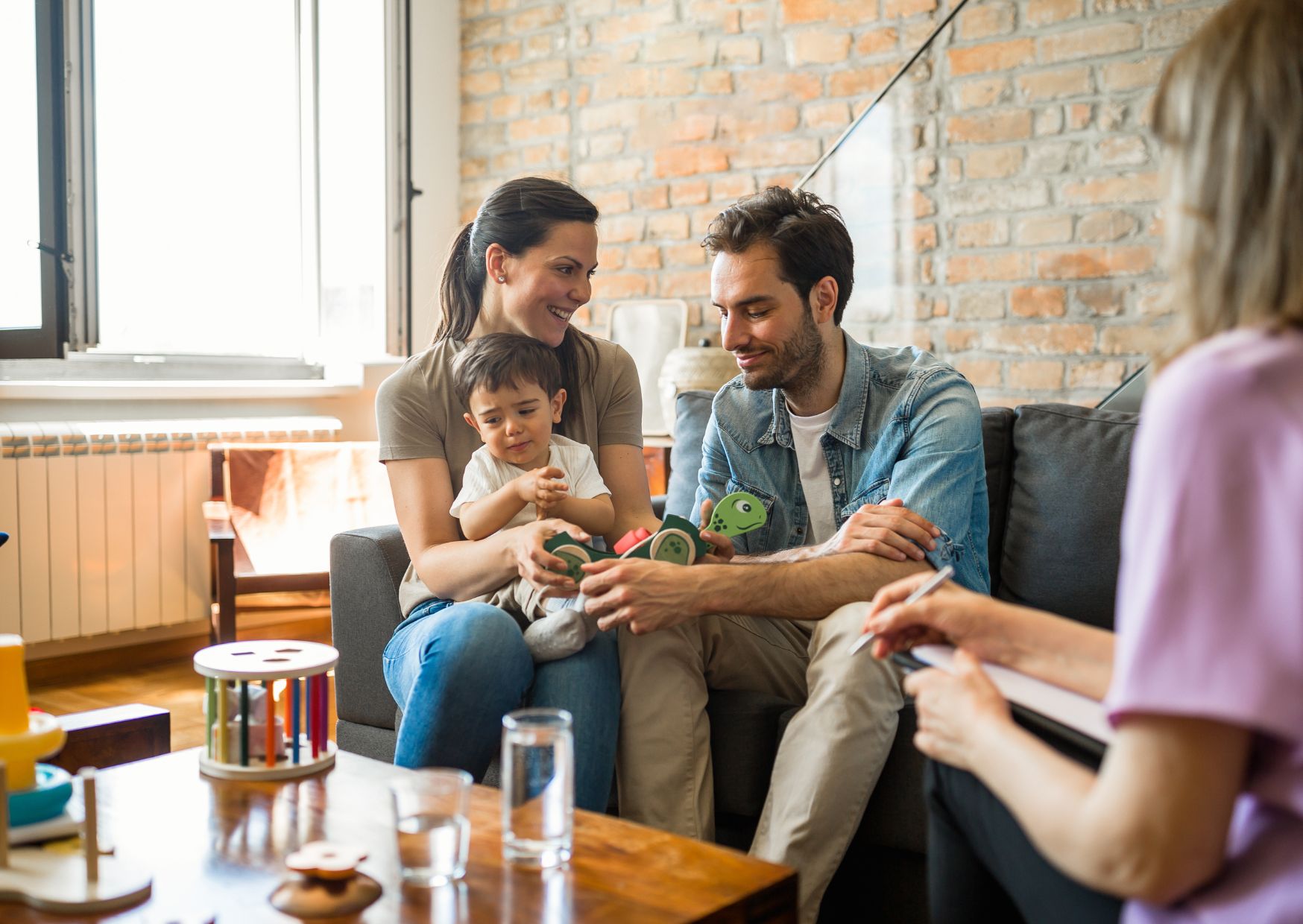 New parents walking with their toddler, transitioning from partners to parents