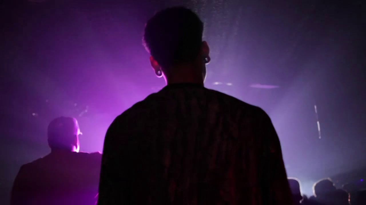 A performer silhouetted against magenta stage light at the Mellow High show.