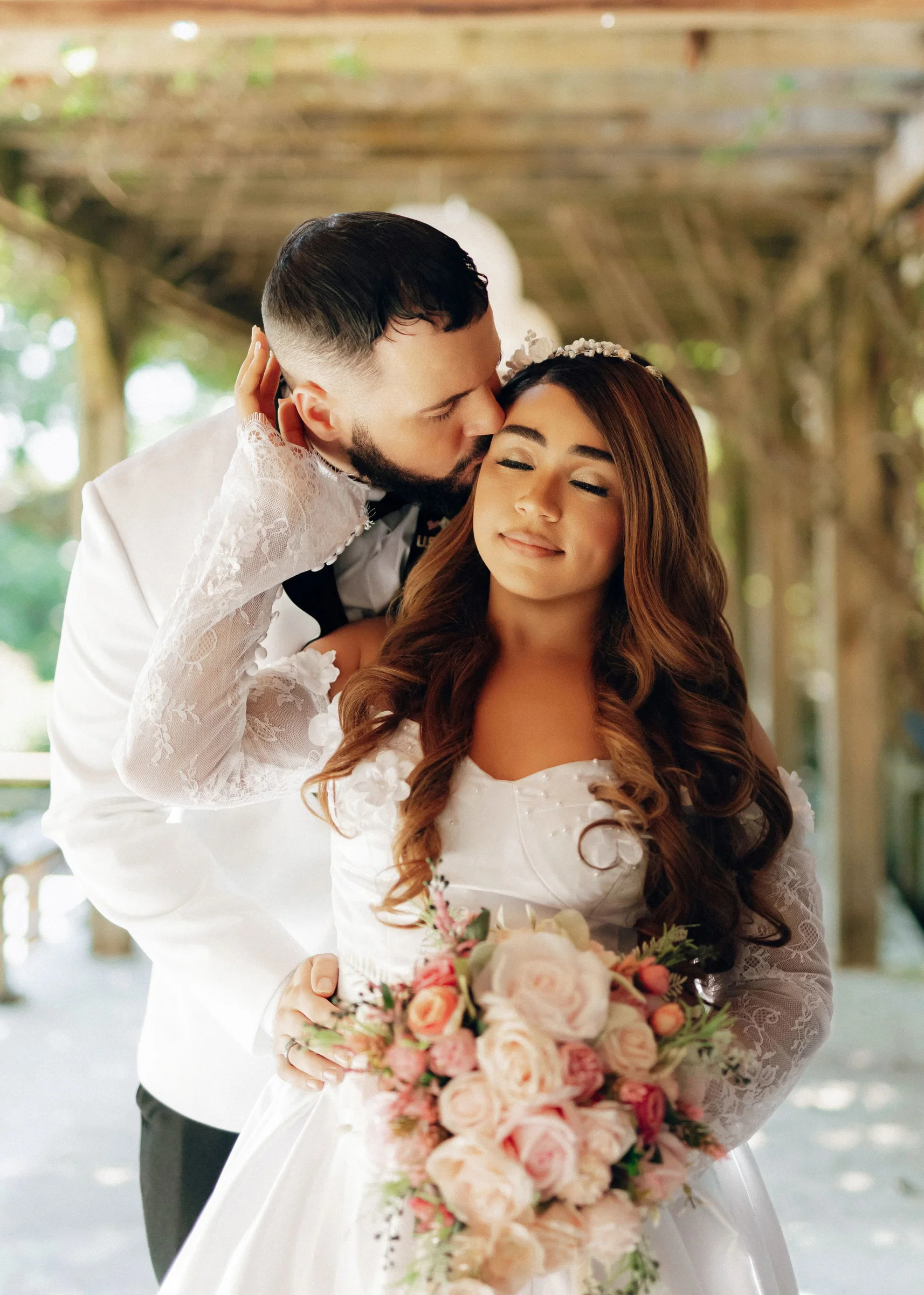 Bride and groom sharing a kiss in the garden