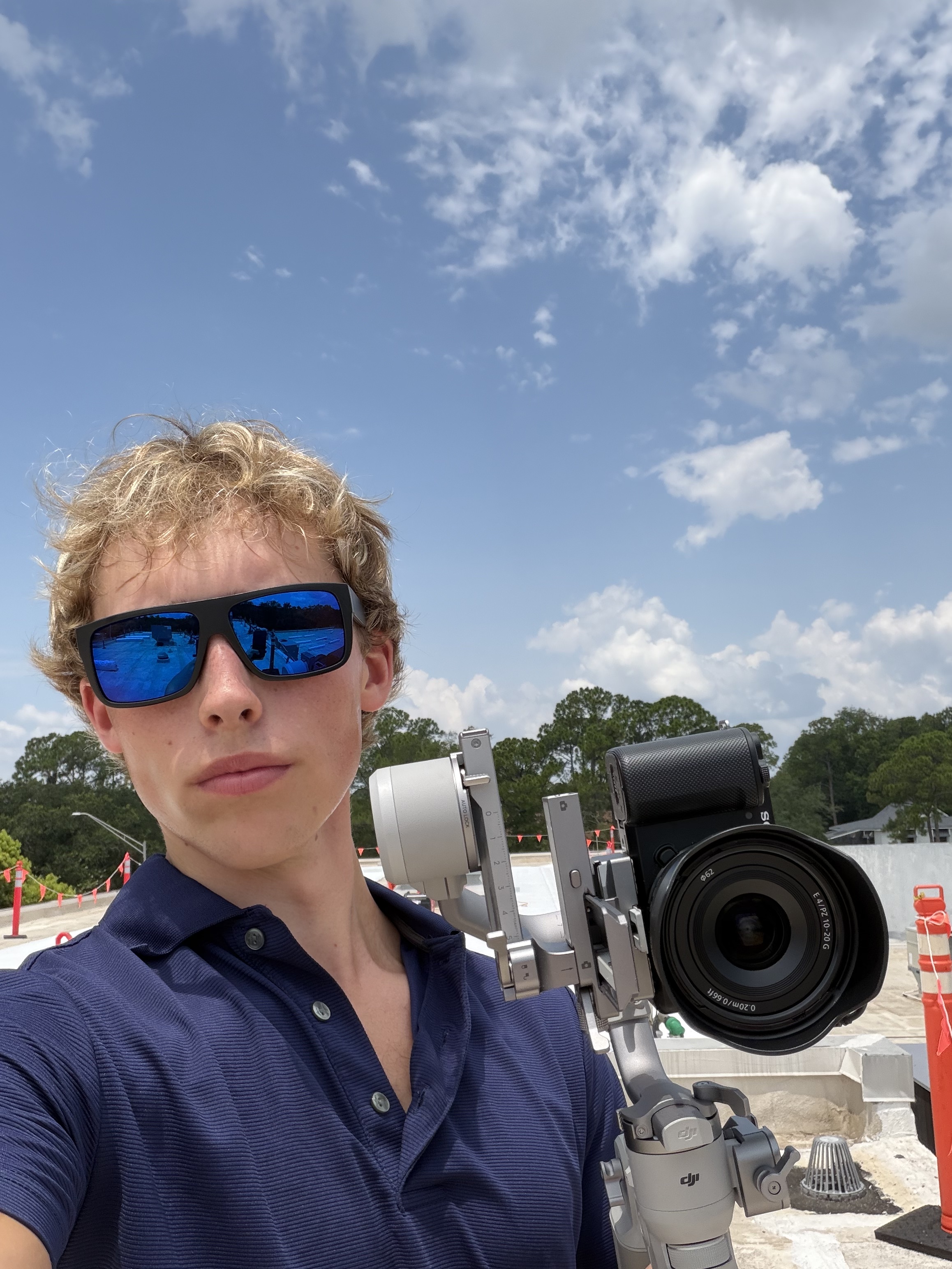 Thomas, founder of ProntoPro Media and Marketing, on a job site with his camera