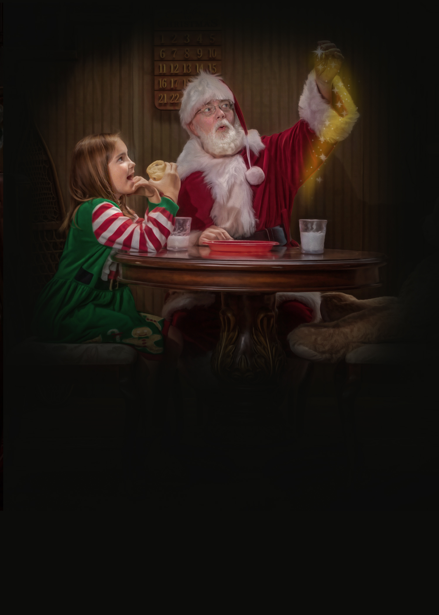 Santa Mike sharing milk and cookies with a child during The Magic of Santa experience
