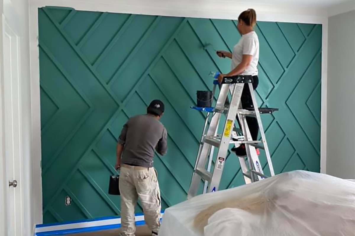 Professional painter painting an interior wall.