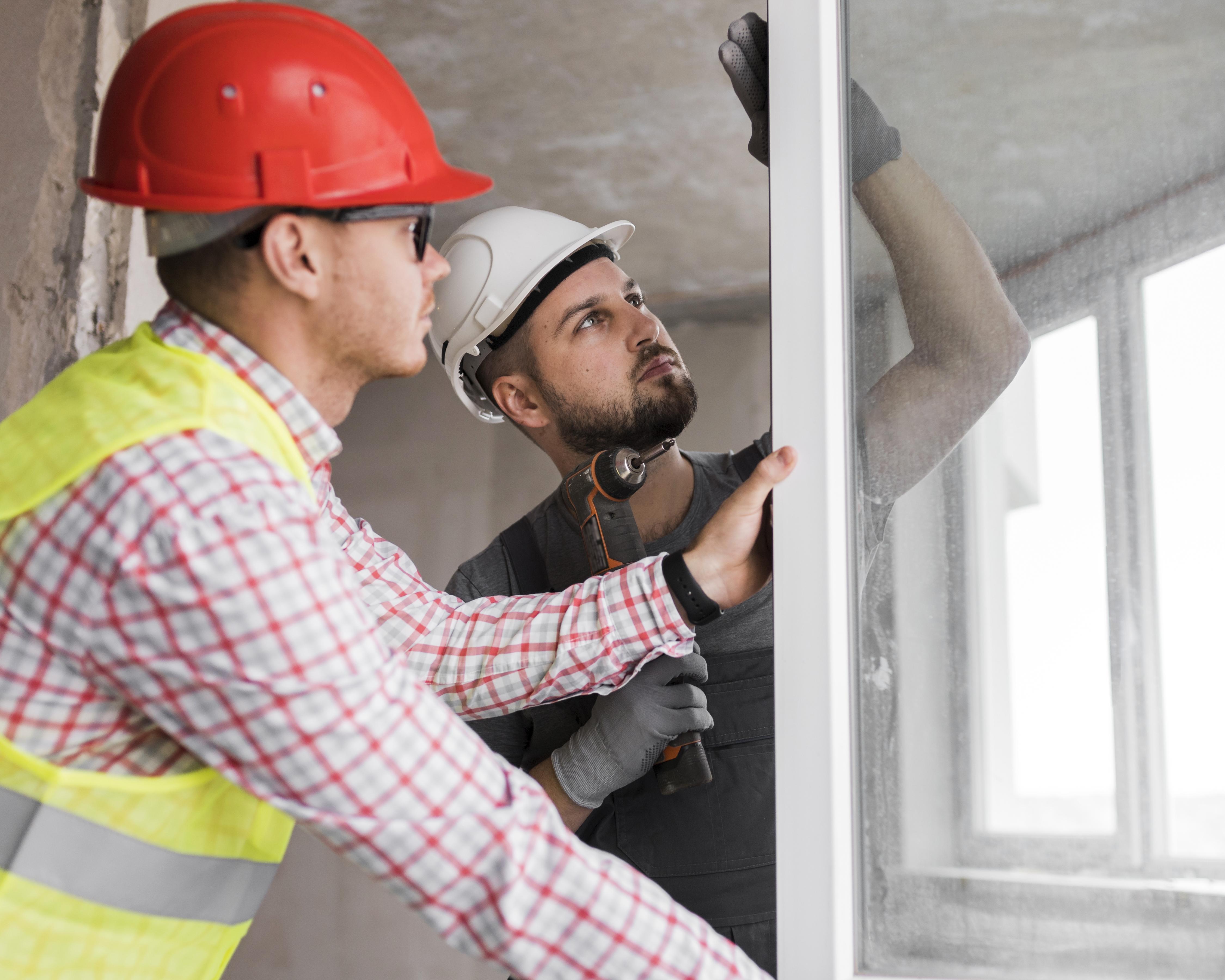 Professional painter applying fresh white paint to interior wall