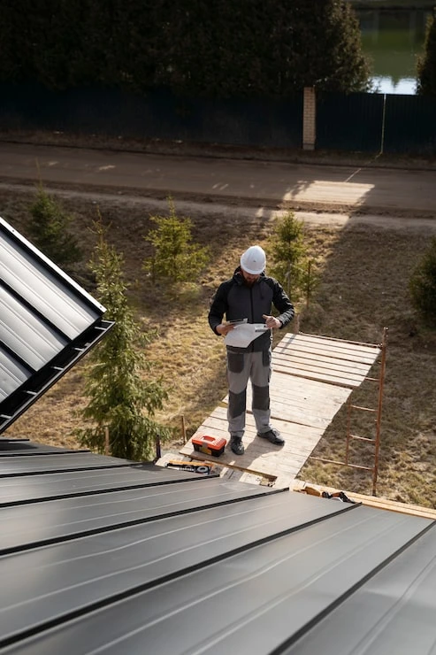 Roofing contractor performing a detailed residential roof inspection in Kernersville, NC to assess roof condition and maintenance needs.