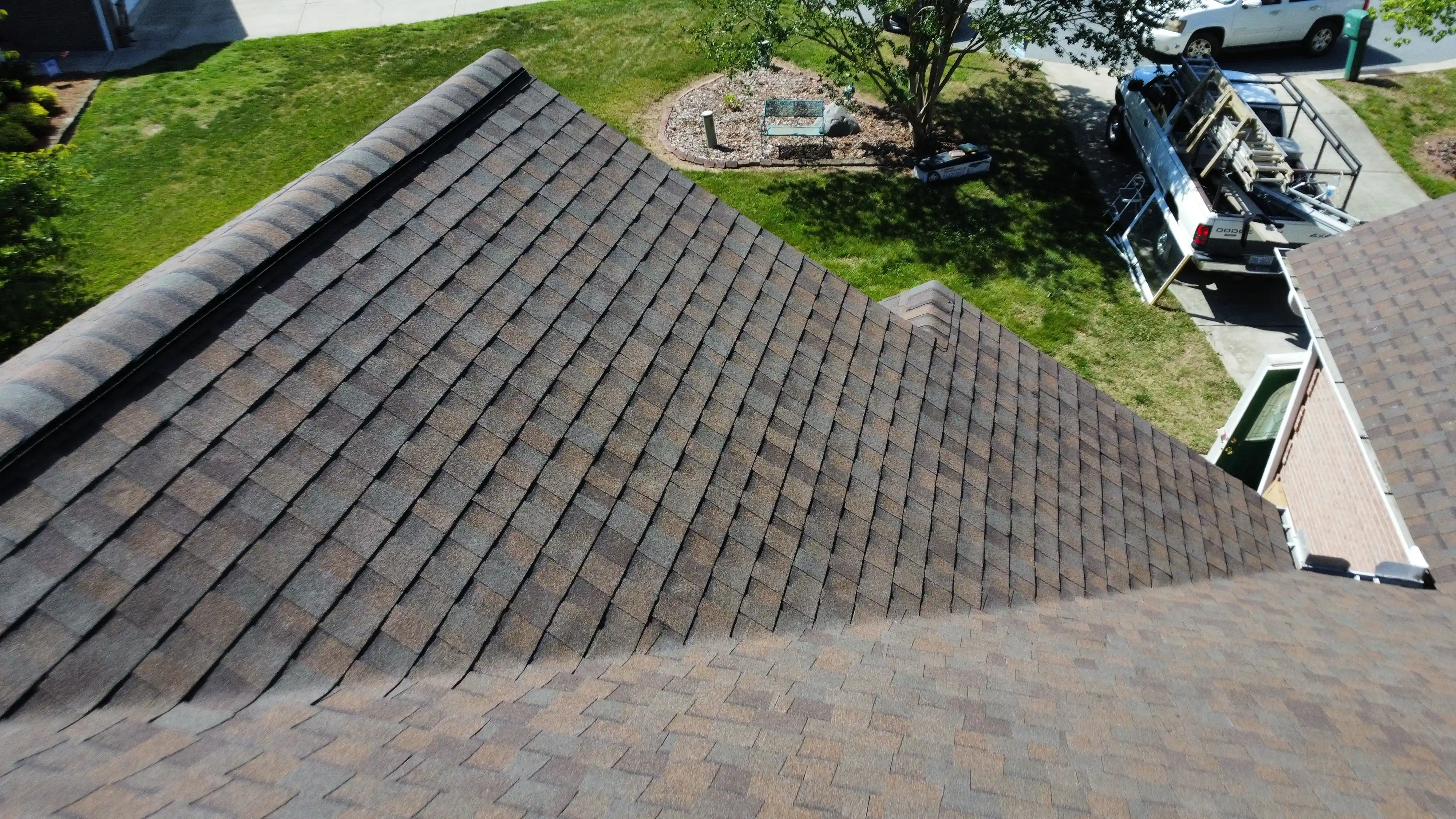 Professional roofing contractors installing roofing materials on a residential property