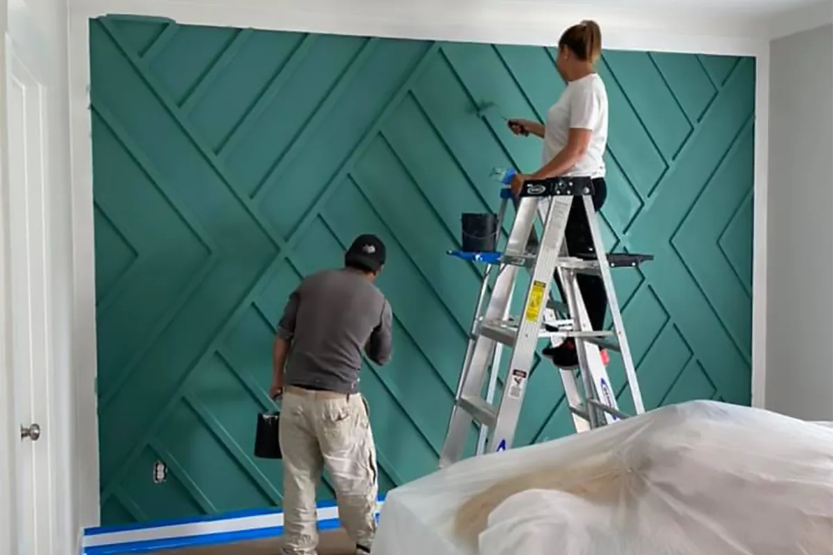 Professional painter painting an interior wall.