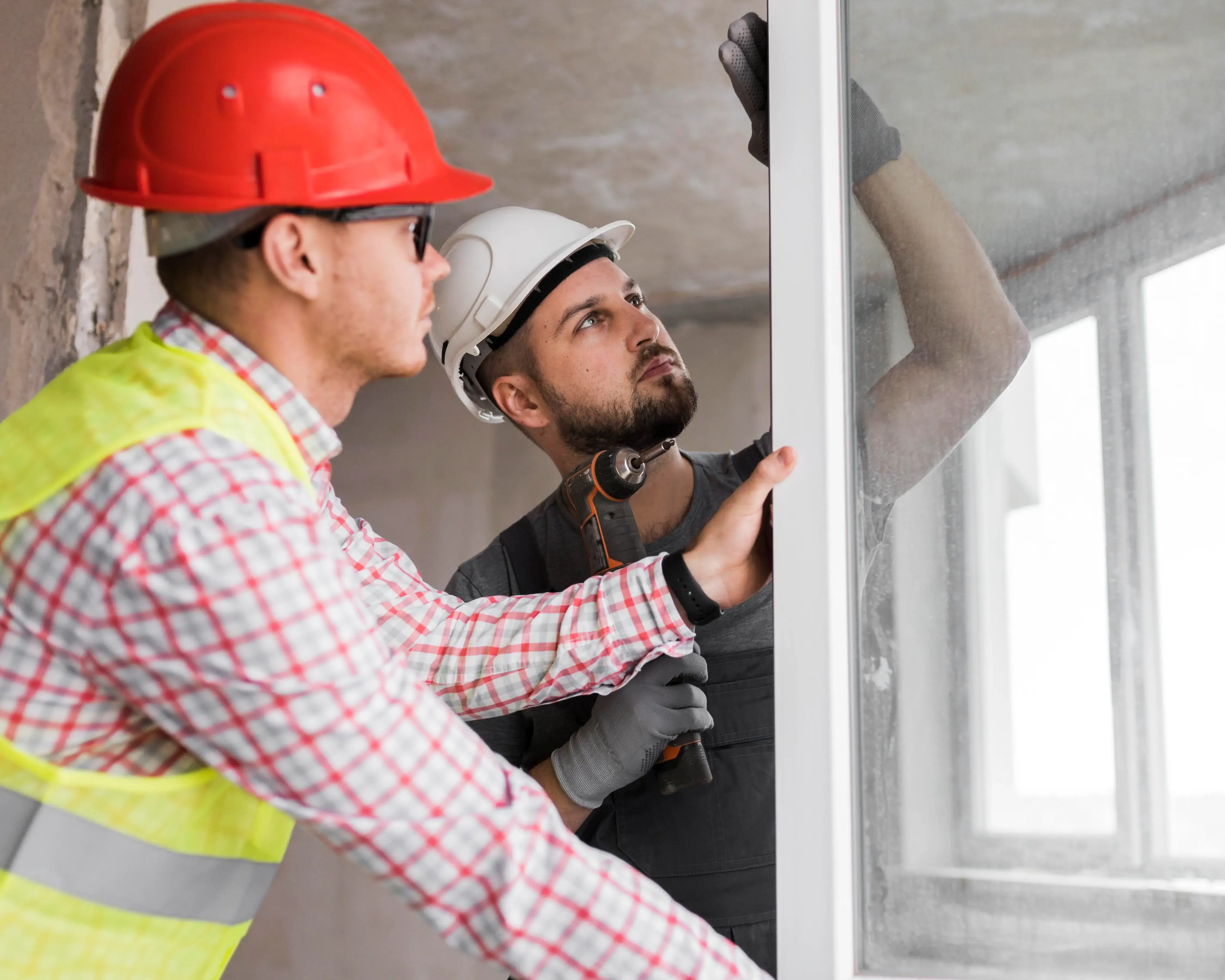Professional painter applying fresh white paint to interior wall