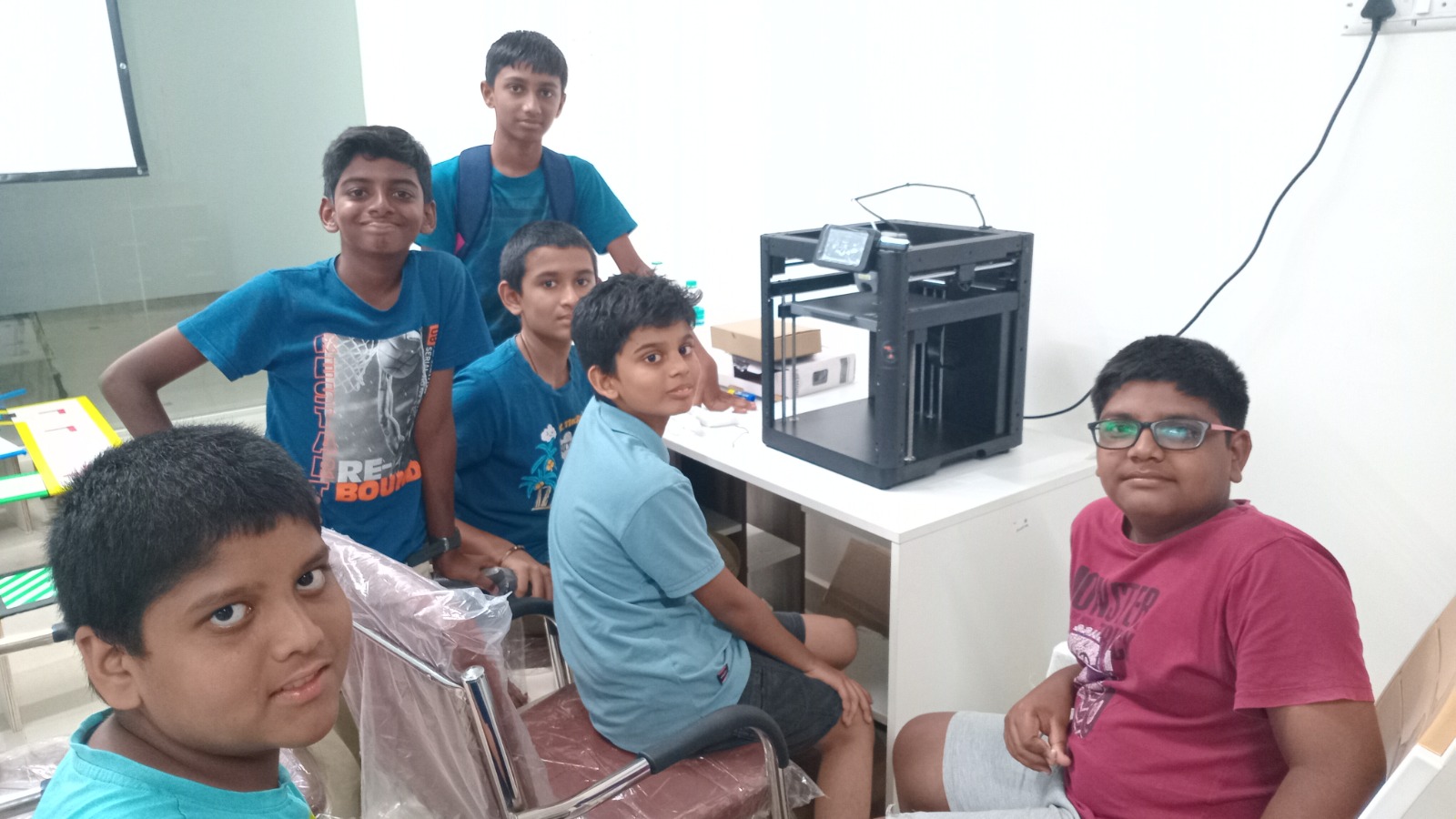 Children building a robot in the lab