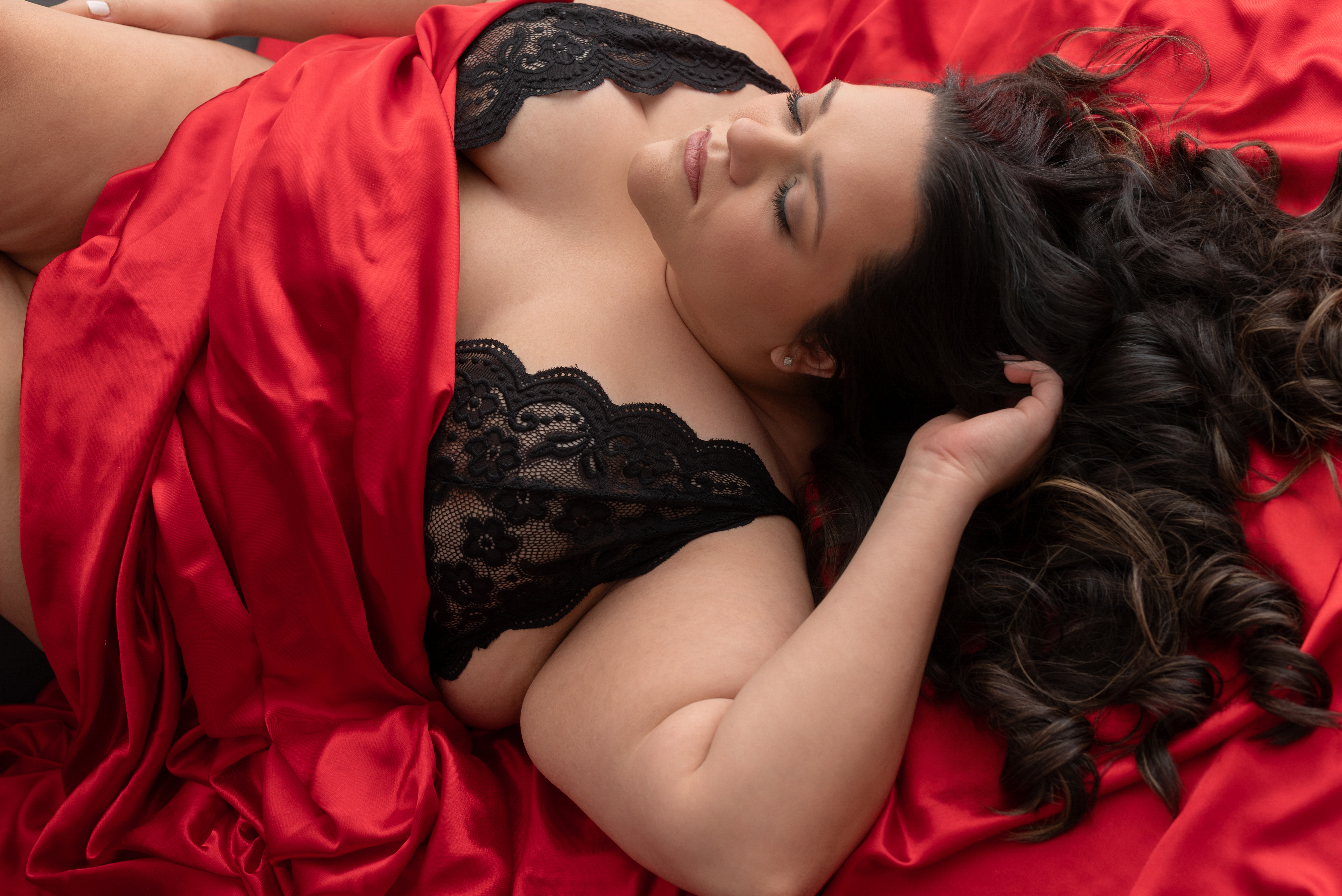 Portrait of Nicole in red sheets from her boudoir photoshoot with Cory Powell Photography in Springfield, MO