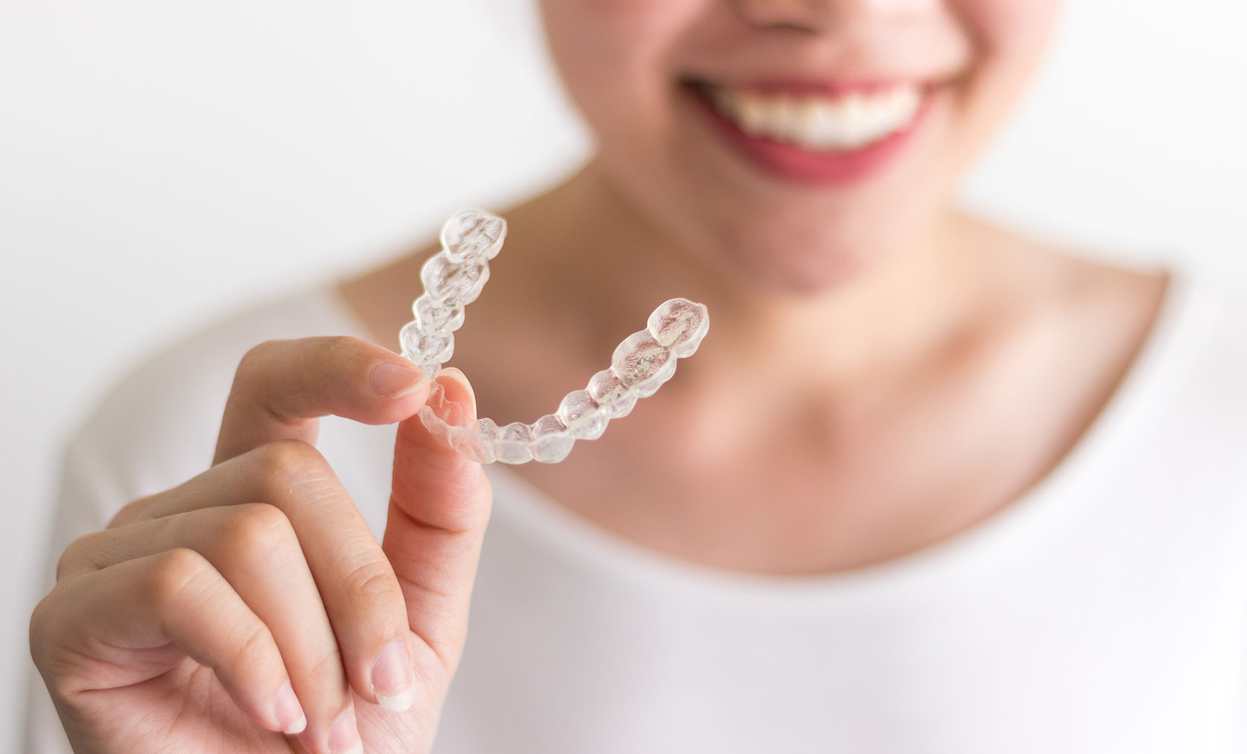 Woman holding invisalign