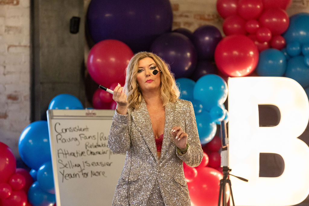 Crissy Conner speaking on stage with a microphone