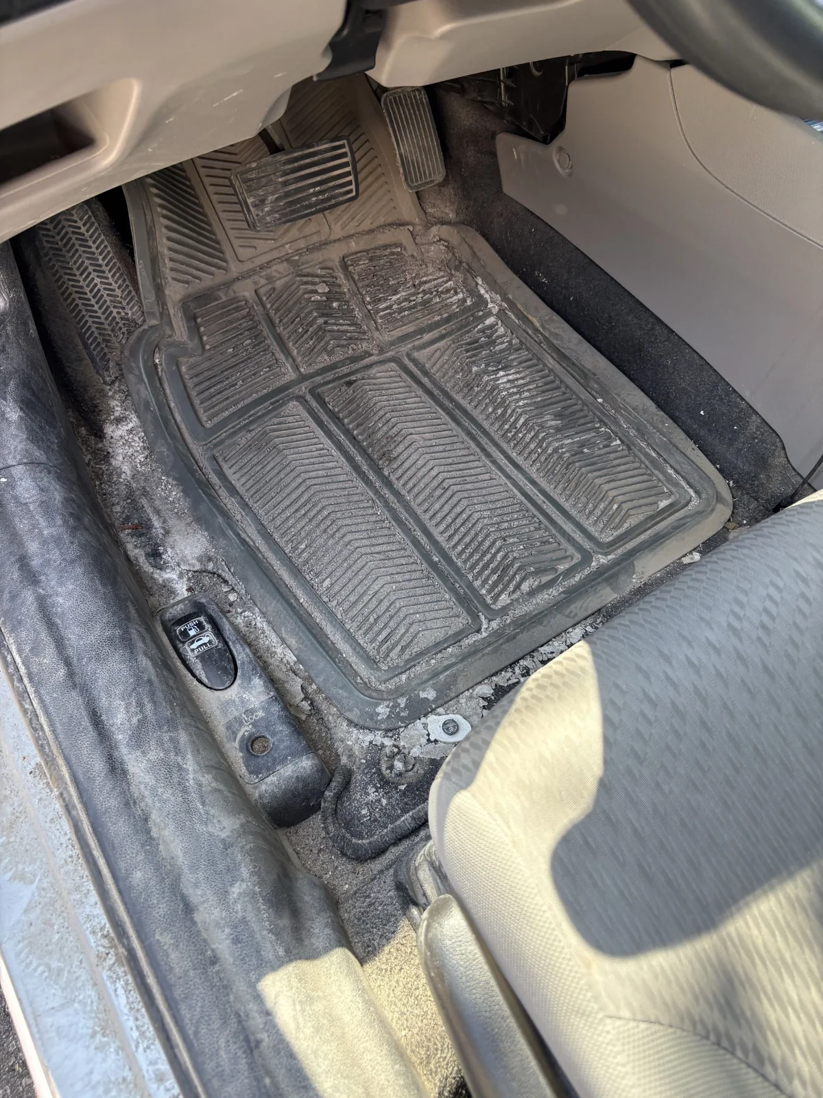 Salt-covered vehicle mat before complete mobile detailing
