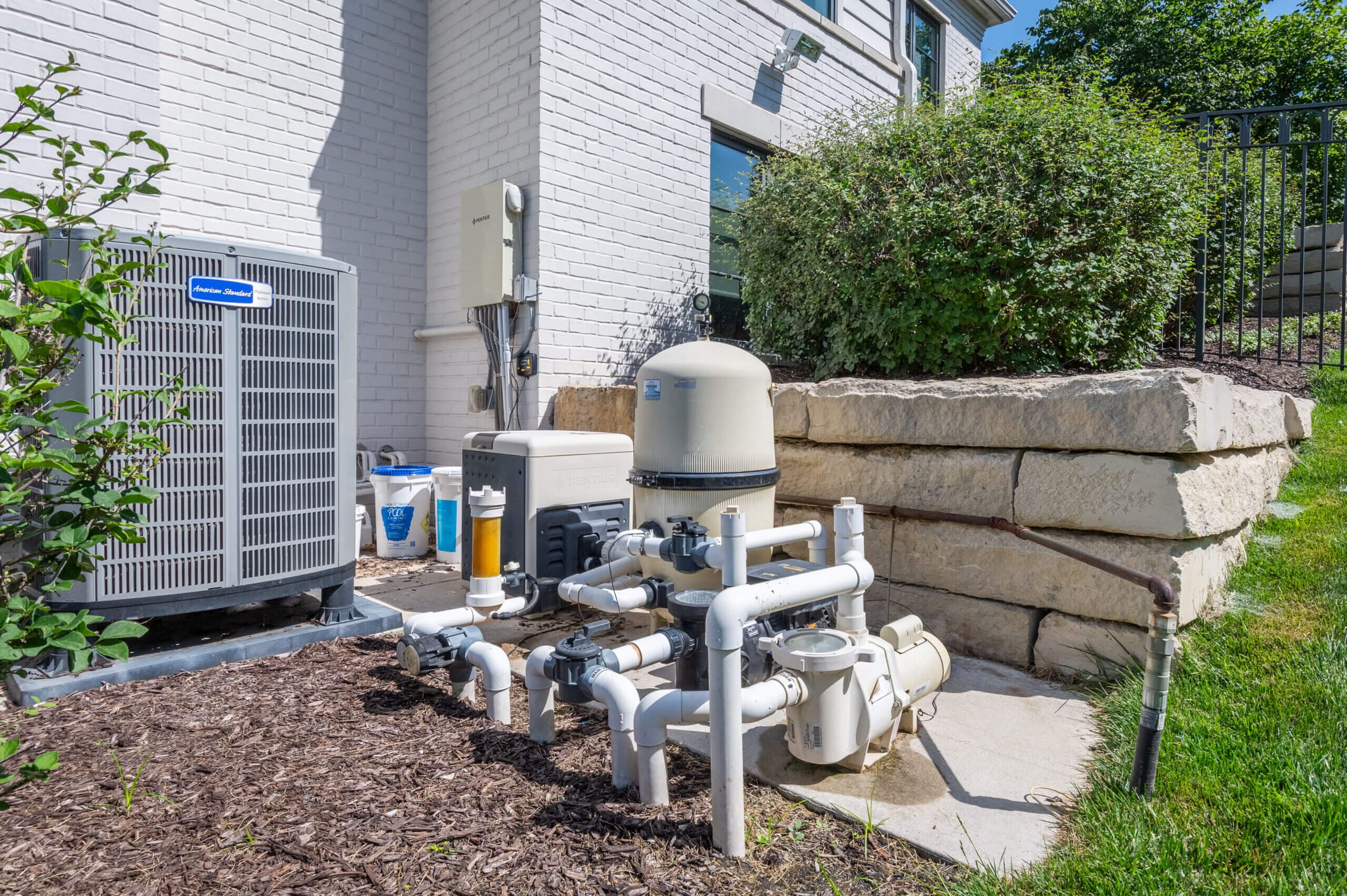 Pool equipment pad with pump, filter, and plumbing components