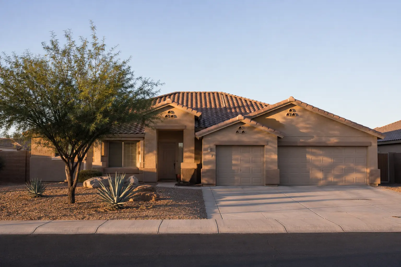 Single-story stucco home with three-car garage and desert landscaping in Maricopa, Arizona