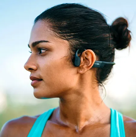 Shokz open-ear headphones on a runner